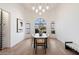 Bright dining room with a modern table, decorative chandelier, and large windows at 10541 E Windrose Dr, Scottsdale, AZ 85259