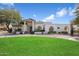 Stunning home with a beautiful lawn and manicured landscaping in front at 10541 E Windrose Dr, Scottsdale, AZ 85259