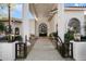 Elegant covered front entryway with an iron gate and door at 10541 E Windrose Dr, Scottsdale, AZ 85259