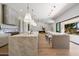 Spacious kitchen with double islands, bar seating, and modern lighting at 10541 E Windrose Dr, Scottsdale, AZ 85259