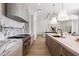 Open kitchen with marble countertops, stainless steel appliances, and hardwood floors at 10541 E Windrose Dr, Scottsdale, AZ 85259