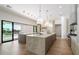 Gourmet kitchen with double islands, bar seating, and modern lighting at 10541 E Windrose Dr, Scottsdale, AZ 85259
