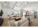 Bright living room with vaulted ceilings, skylights, modern furniture, and access to the backyard at 10541 E Windrose Dr, Scottsdale, AZ 85259