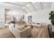 Open-concept living room with a modern design, hardwood floors, and a clear view of the kitchen at 10541 E Windrose Dr, Scottsdale, AZ 85259