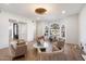 Bright living room featuring a vaulted ceiling, hardwood floors, stylish furniture, and a unique light fixture at 10541 E Windrose Dr, Scottsdale, AZ 85259