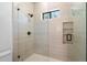 Glass enclosed shower featuring a rainfall shower head, with a built-in shelf at 10541 E Windrose Dr, Scottsdale, AZ 85259