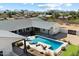 Aerial shot showcasing the backyard swimming pool with lounge chairs, landscaping, and neighboring homes at 11212 N Miller Rd, Scottsdale, AZ 85260