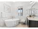 Bright bathroom features a free standing tub, vanity with granite countertops, and modern fixtures at 11212 N Miller Rd, Scottsdale, AZ 85260