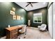 Stylish bedroom featuring a wooden desk, accent chair, and decorative wall art at 11212 N Miller Rd, Scottsdale, AZ 85260