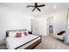 Bright bedroom features a ceiling fan, and direct access to the ensuite bathroom at 11212 N Miller Rd, Scottsdale, AZ 85260