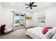 Bright bedroom features a ceiling fan, and sliding glass door access to the backyard at 11212 N Miller Rd, Scottsdale, AZ 85260