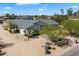 Landscaped home showcasing its lush desert surroundings on a sunny day, exuding charm at 11212 N Miller Rd, Scottsdale, AZ 85260