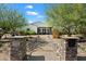 Charming home exterior features a well-manicured front yard, desert landscaping and inviting walkway to the front door at 11212 N Miller Rd, Scottsdale, AZ 85260