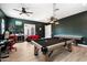 This spacious game room provides access to the outdoor living space and plenty of room for entertainment at 11212 N Miller Rd, Scottsdale, AZ 85260
