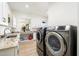 Well-equipped laundry room featuring a sink, modern washer and dryer at 11212 N Miller Rd, Scottsdale, AZ 85260