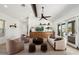Inviting living room boasts stylish furnishings, a large sliding glass door, and seamless flow into the open floor plan at 11212 N Miller Rd, Scottsdale, AZ 85260