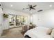 Bright main bedroom with a ceiling fan and sliding glass doors which lead to the outdoor living space at 11212 N Miller Rd, Scottsdale, AZ 85260