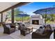 Outdoor living space features a fireplace, comfortable seating, overhead coverage, and patio accents at 11212 N Miller Rd, Scottsdale, AZ 85260