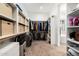 A large walk-in closet that provides tons of storage and organization with access to the main bathroom at 11212 N Miller Rd, Scottsdale, AZ 85260