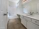 Well-lit bathroom featuring a vanity with storage, a shower and tub combo, and tile floors at 1131 E Catino St, San Tan Valley, AZ 85140