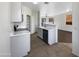 Open kitchen with white cabinets, stainless steel appliances, and a breakfast bar at 1131 E Catino St, San Tan Valley, AZ 85140