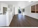 Open floor plan with wood floors, ceiling fan, and sliding glass door to the backyard at 1131 E Catino St, San Tan Valley, AZ 85140