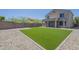 Low-maintenance backyard featuring artificial grass and gravel, fully fenced for privacy at 1236 E Mescal St, Phoenix, AZ 85020