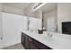 Bathroom featuring double sinks, a large mirror, and a shower with a white curtain at 1236 E Mescal St, Phoenix, AZ 85020