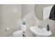 Half-bathroom with a vessel sink, decorative mirror, and neutral color palette at 1236 E Mescal St, Phoenix, AZ 85020