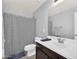 Well-lit bathroom featuring a shower with patterned curtain and integrated sink at 1236 E Mescal St, Phoenix, AZ 85020