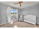 Charming Bedroom featuring a crib, cozy glider, and a view of the neighborhood at 1236 E Mescal St, Phoenix, AZ 85020