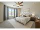 Beautifully furnished bedroom with a ceiling fan, neutral colors, and large window at 1236 E Mescal St, Phoenix, AZ 85020