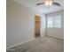 Bedroom with carpeted floor, ceiling fan, and a walk-in closet at 1236 E Mescal St, Phoenix, AZ 85020