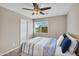 Well-lit bedroom featuring a window view, a bed, and a ceiling fan at 1236 E Mescal St, Phoenix, AZ 85020