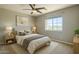 Beautifully staged bedroom with serene artwork, large window and natural light at 1236 E Mescal St, Phoenix, AZ 85020