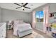 Bright bedroom features a ceiling fan, mountain views, and soft, natural light at 1236 E Mescal St, Phoenix, AZ 85020