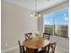 Cozy breakfast nook with a round wood table, four chairs, and a chandelier, lit by a bright window at 1236 E Mescal St, Phoenix, AZ 85020