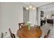 Bright breakfast nook with a round wood table, four chairs, and a chandelier, with kitchen view at 1236 E Mescal St, Phoenix, AZ 85020