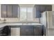 Modern kitchen featuring granite countertops, stainless steel appliances, and sleek, dark cabinetry at 1236 E Mescal St, Phoenix, AZ 85020