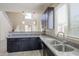 Stylish kitchen with granite counters, dark cabinets, and a seamless flow into the living area at 1236 E Mescal St, Phoenix, AZ 85020