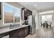 Bright kitchen featuring stainless steel appliances, dark cabinets, and double bowl sink under a window at 1236 E Mescal St, Phoenix, AZ 85020