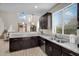 Kitchen with stainless steel appliances, dark wood cabinets, and light wood floors at 1236 E Mescal St, Phoenix, AZ 85020