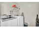 Organized laundry room with modern washer, dryer, and shelving for supplies at 1236 E Mescal St, Phoenix, AZ 85020