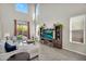 Bright living room with tall windows and a sliding door to the backyard at 1236 E Mescal St, Phoenix, AZ 85020