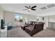 Upstairs living room area featuring a large brown leather sectional sofa and a ceiling fan at 1236 E Mescal St, Phoenix, AZ 85020