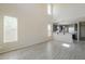 Spacious living room featuring tall windows, neutral walls, and stylish tile flooring at 1236 E Mescal St, Phoenix, AZ 85020