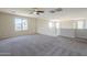 Bright and open loft space featuring a ceiling fan and staircase at 1236 E Mescal St, Phoenix, AZ 85020