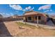 Backyard featuring a covered patio, a dog, and desert landscaping at 13547 W Peck Dr, Litchfield Park, AZ 85340