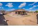 Backyard featuring a covered patio, a dog, and plenty of space at 13547 W Peck Dr, Litchfield Park, AZ 85340