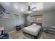 Comfortable bedroom featuring tile floors, a ceiling fan, and lots of natural light at 13547 W Peck Dr, Litchfield Park, AZ 85340
